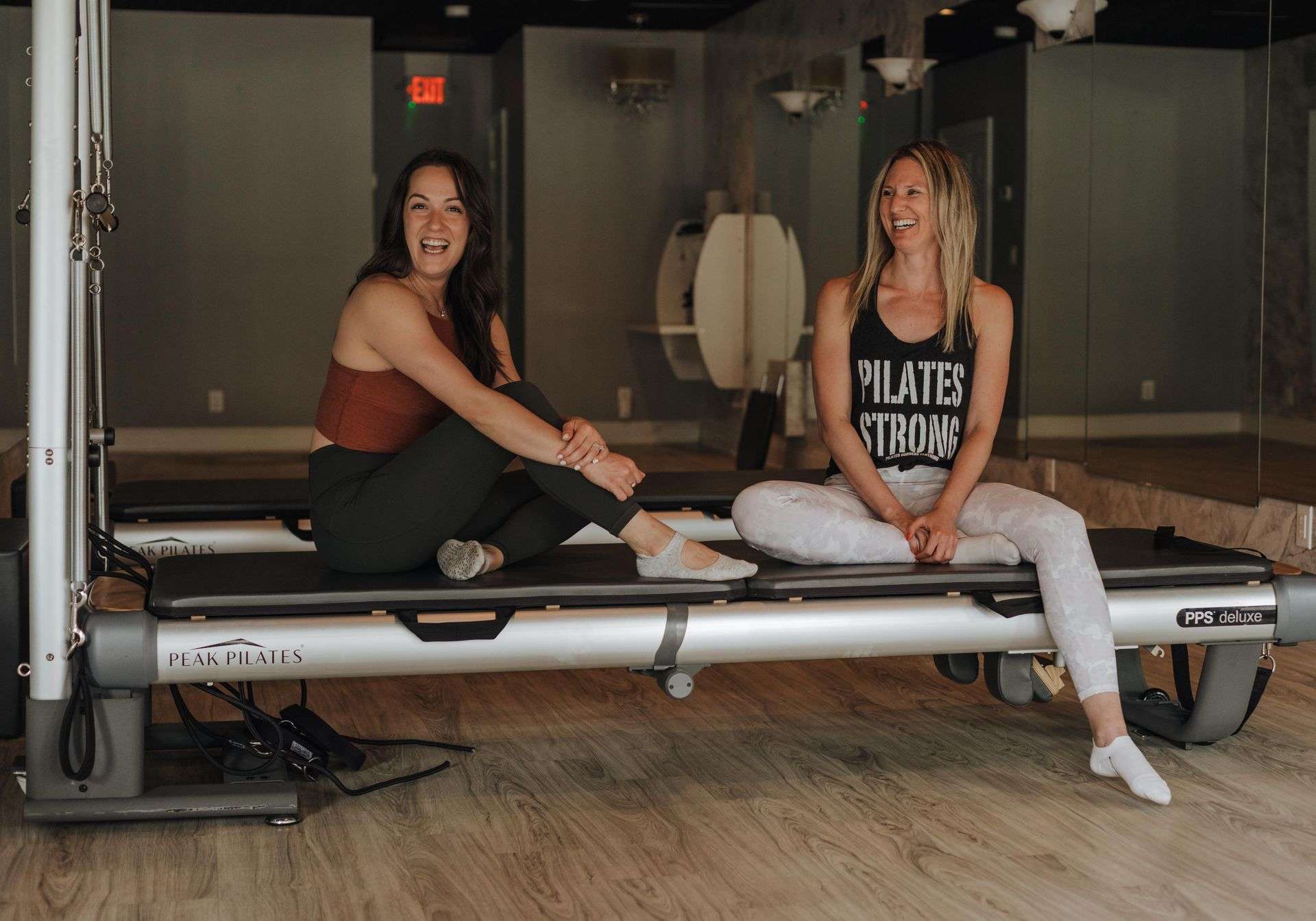 Two members on a Peak Pilates reformer at CSFit Pilates