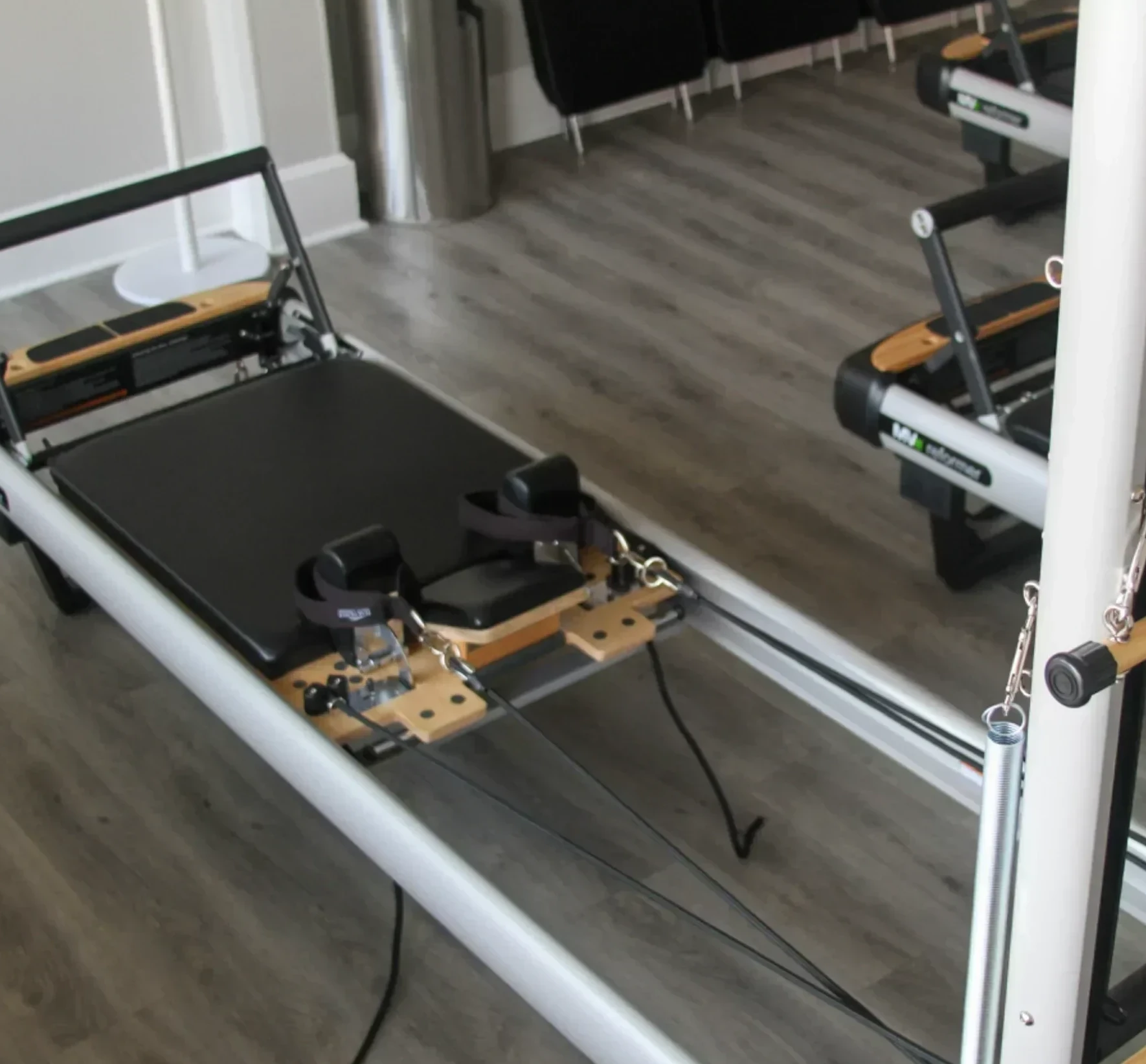 Two members training together during a duet Pilates session at CS Fit Pilates